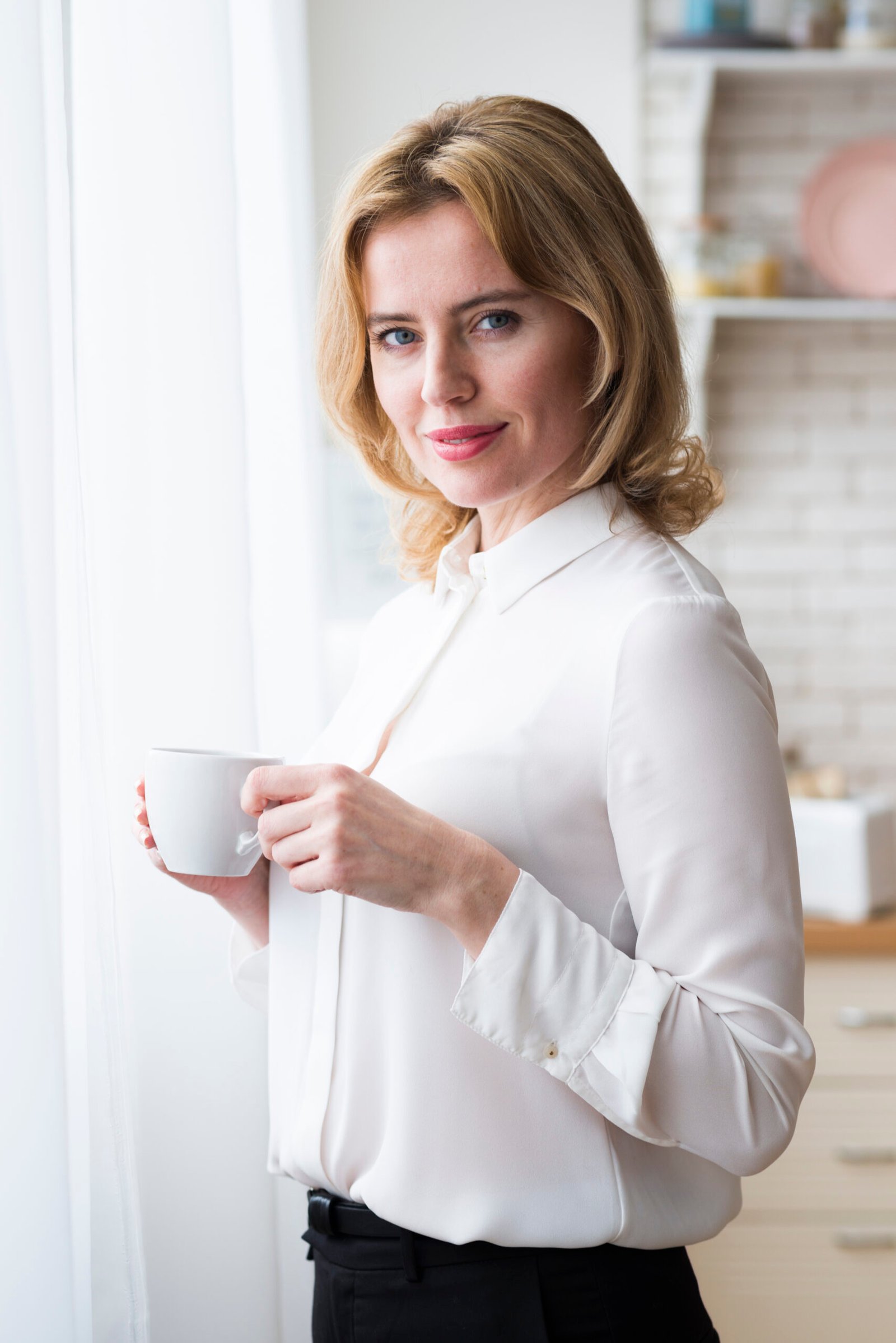 “Layla at her café counter with a latte